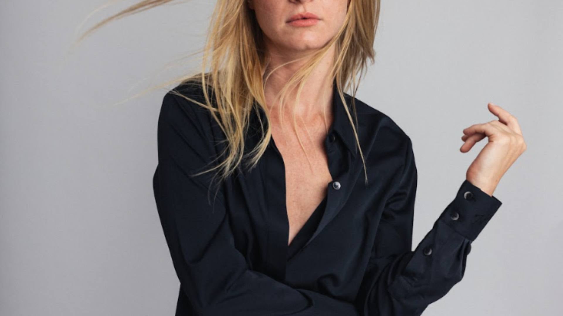 A person wears a sustainable black top.